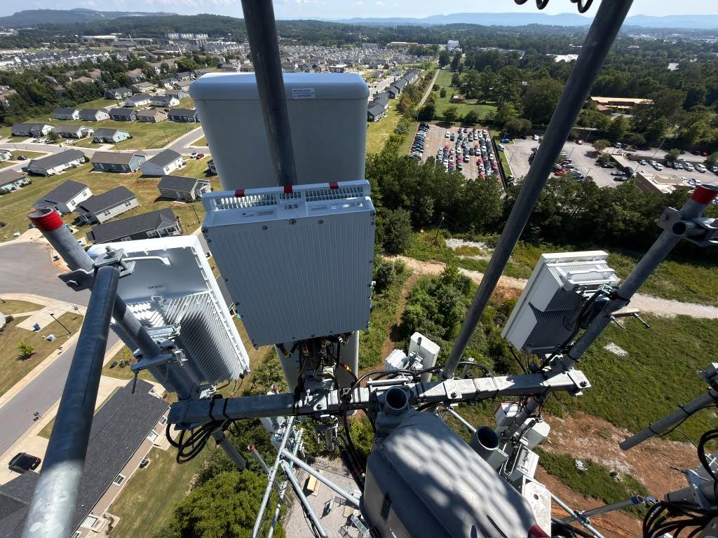 Finished Verizon 5G equipment install on a tower above a residential neighborhood