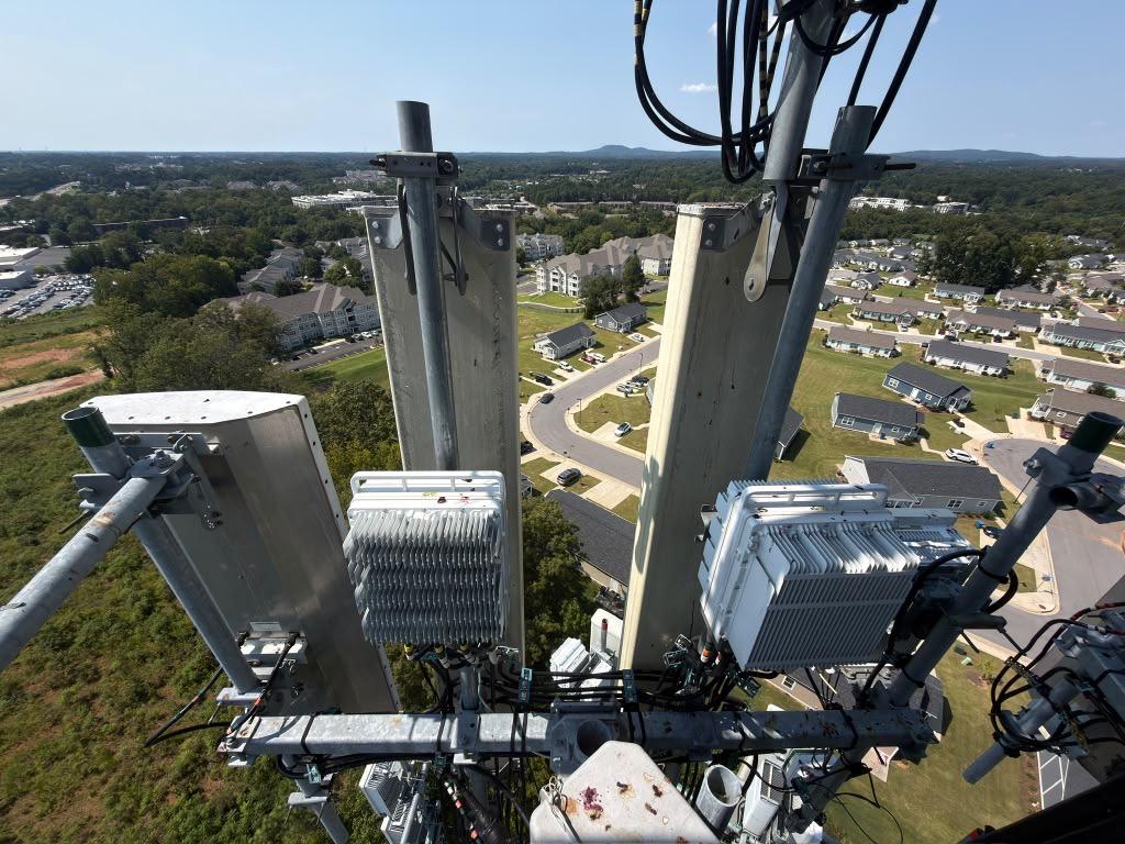 Existing radios and antenna panels on a Verizon tower before the 5G upgrade