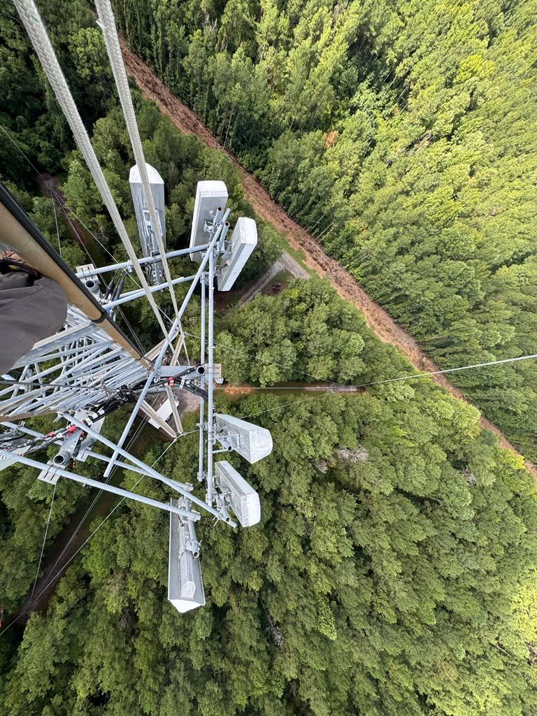 Top-down view of a Verizon tower mount above the forest before 5G installation
